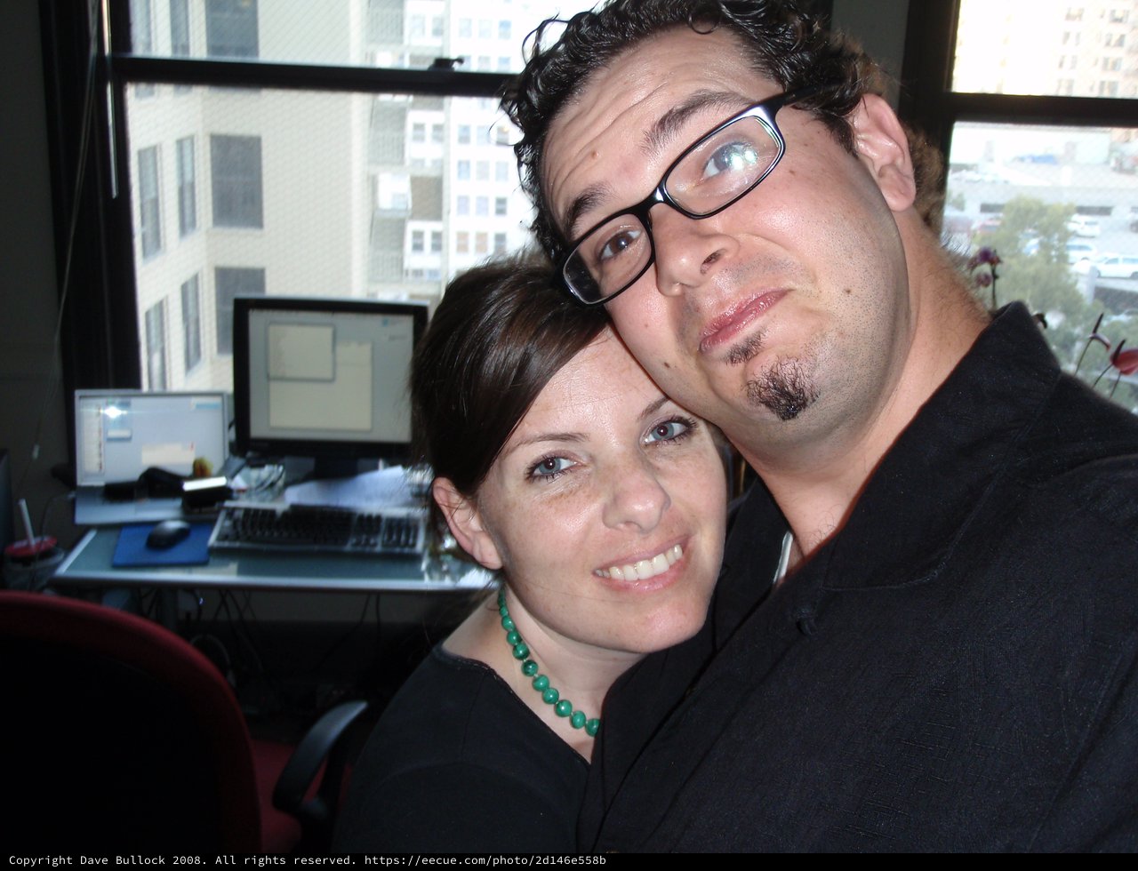 Couple Poses Cheek to Cheek in Office Setting