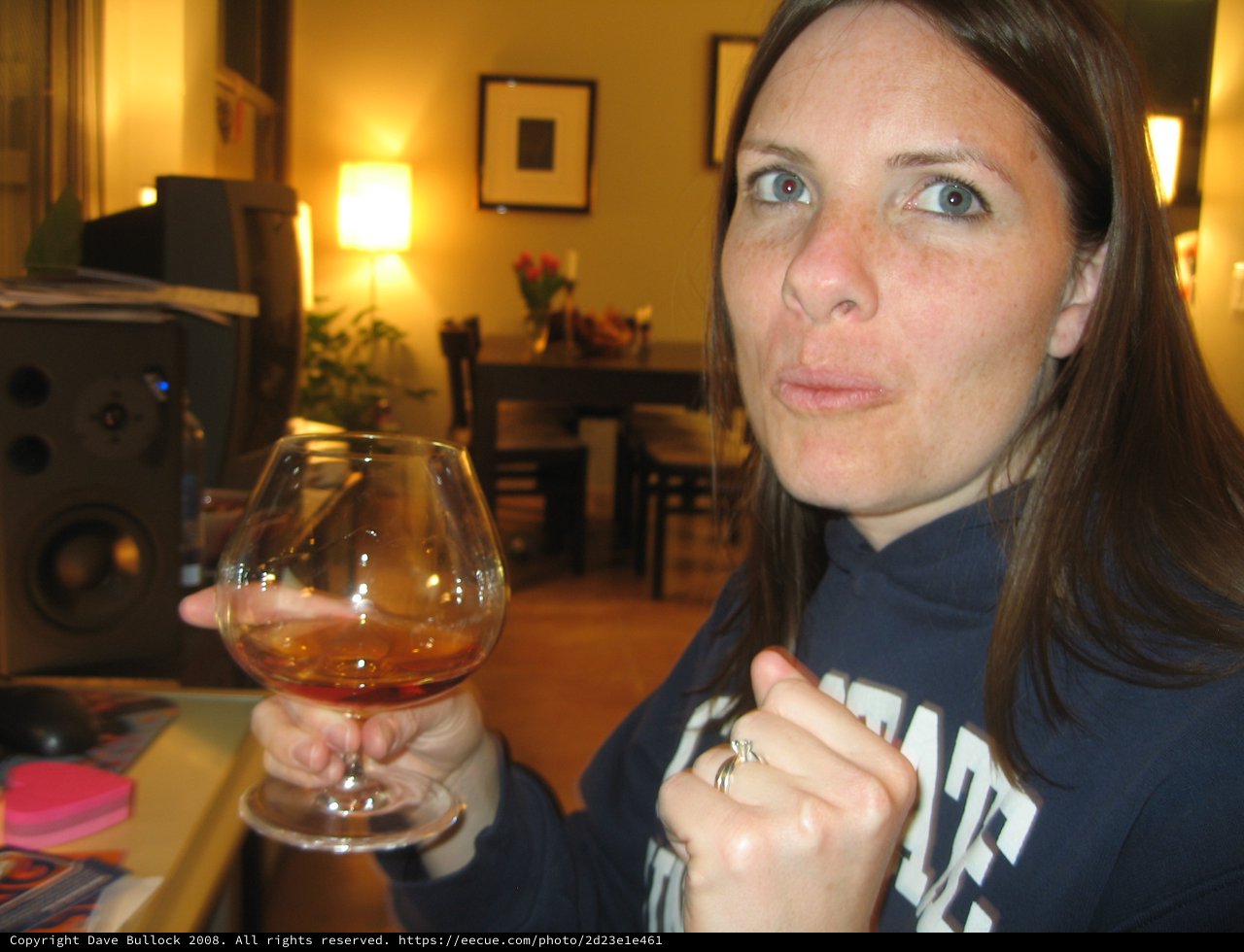 Woman Enjoying Brandy in Cozy Living Room
