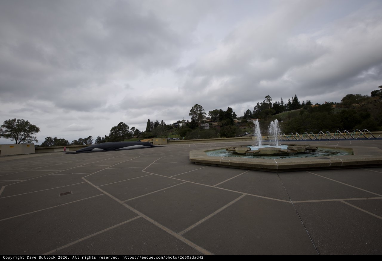 Cloudy Plaza with Fountain and Modernist Sculpture