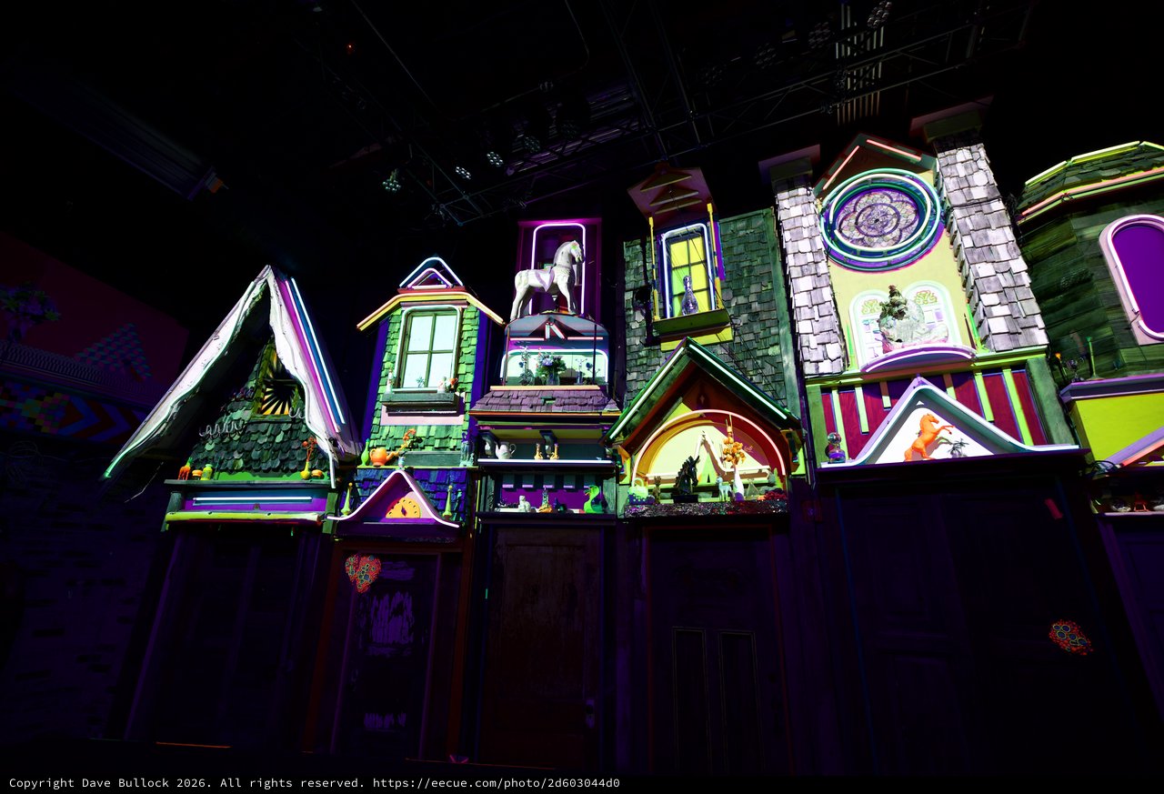 Whimsical Neon-Lit Miniature Village Display at Night