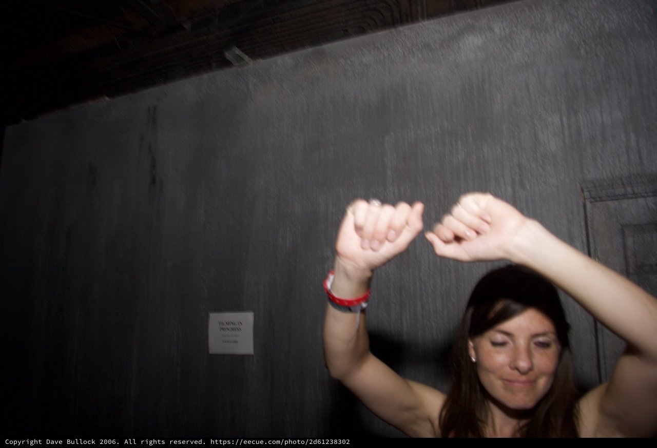 Woman Dancing with Arms Raised at Night Event