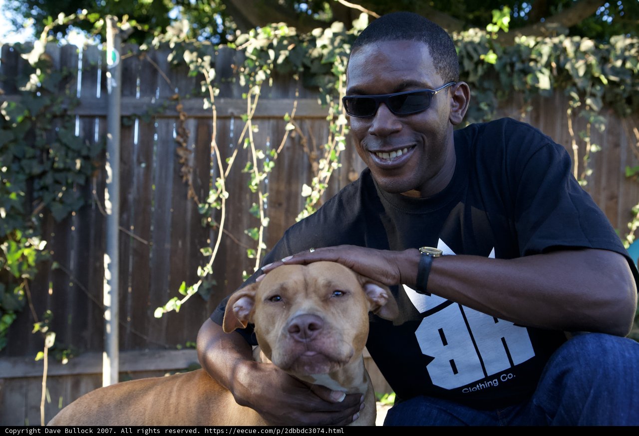 Man and Happy Dog by the Fence