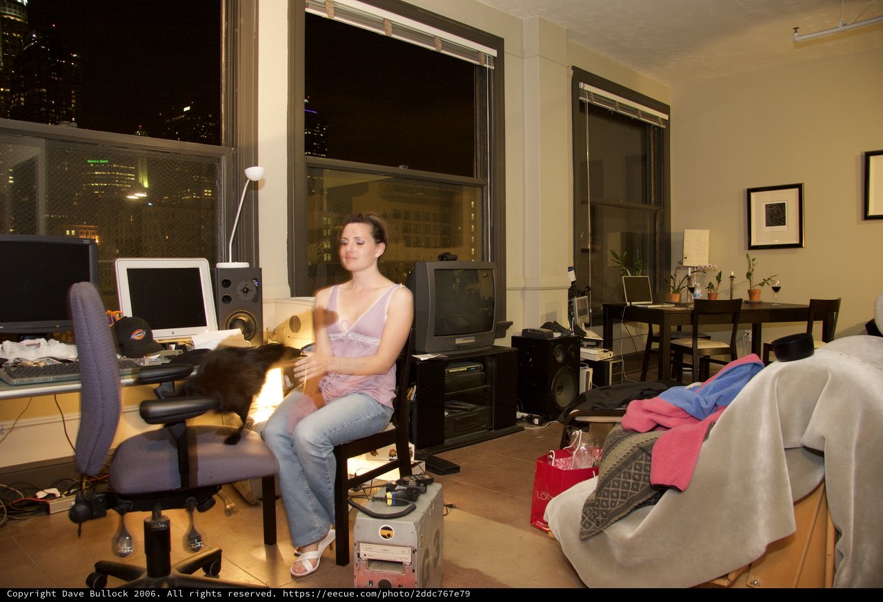 Young Woman Relaxing with Cat in City Apartment
