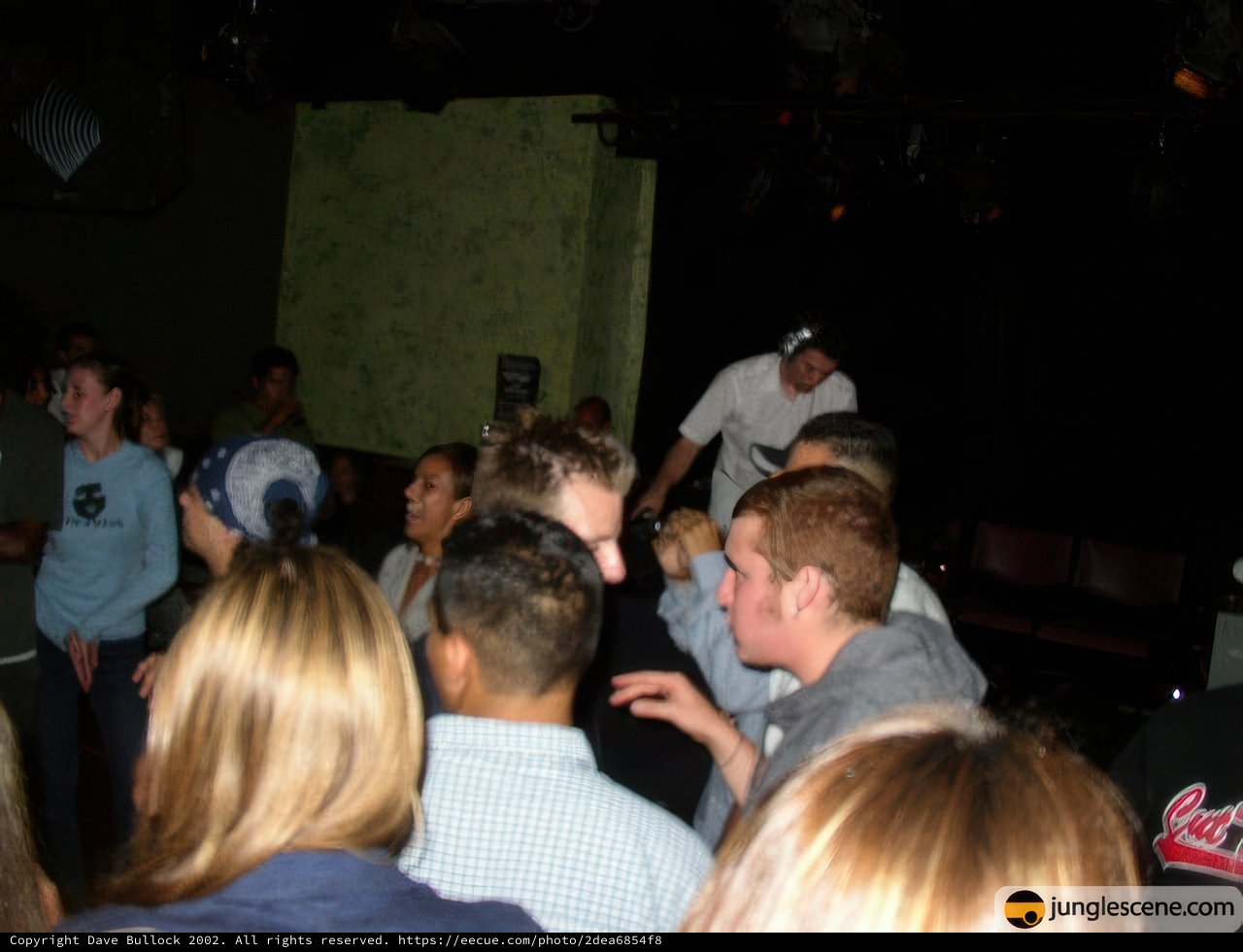 Crowd gathers around man at nightclub