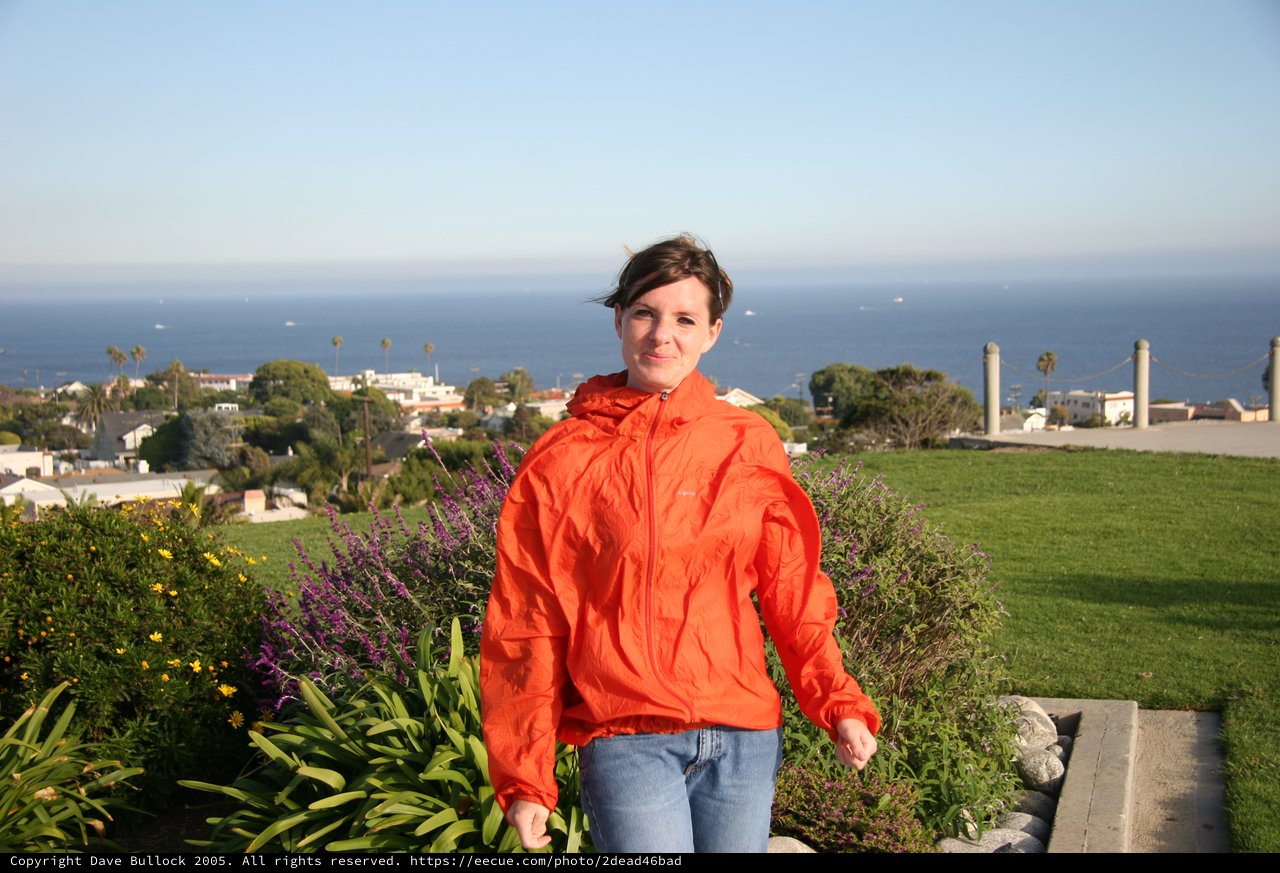 Woman in Orange Jacket Overlooking Coastal California Town