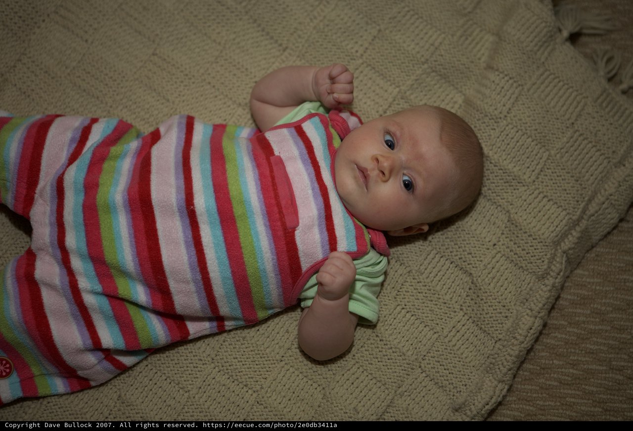 Bright-Eyed Baby Resting on Knit Blanket