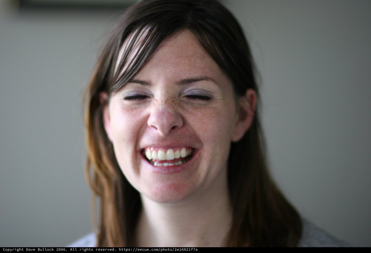 Joyful Woman Laughing with Eyes Closed