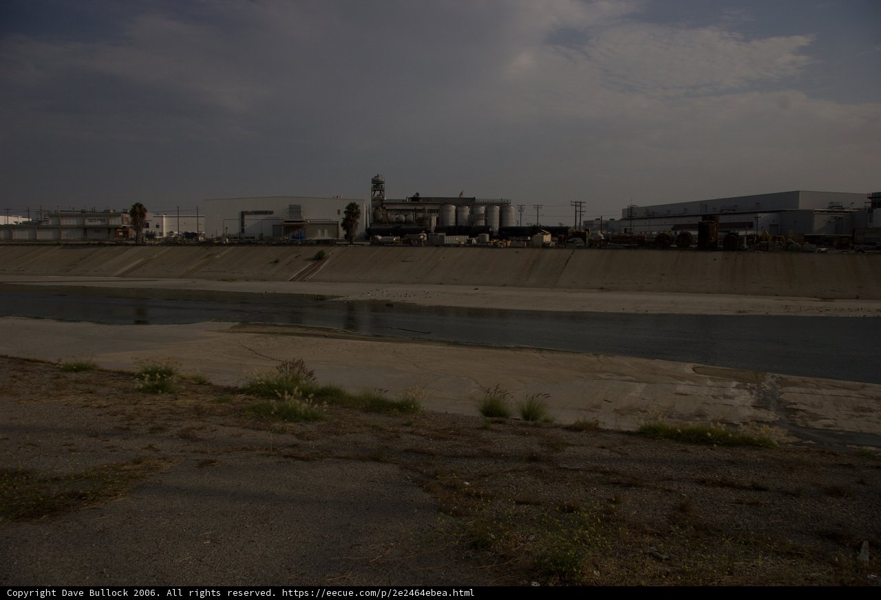 Majestic River with Industrial Structure in the Background