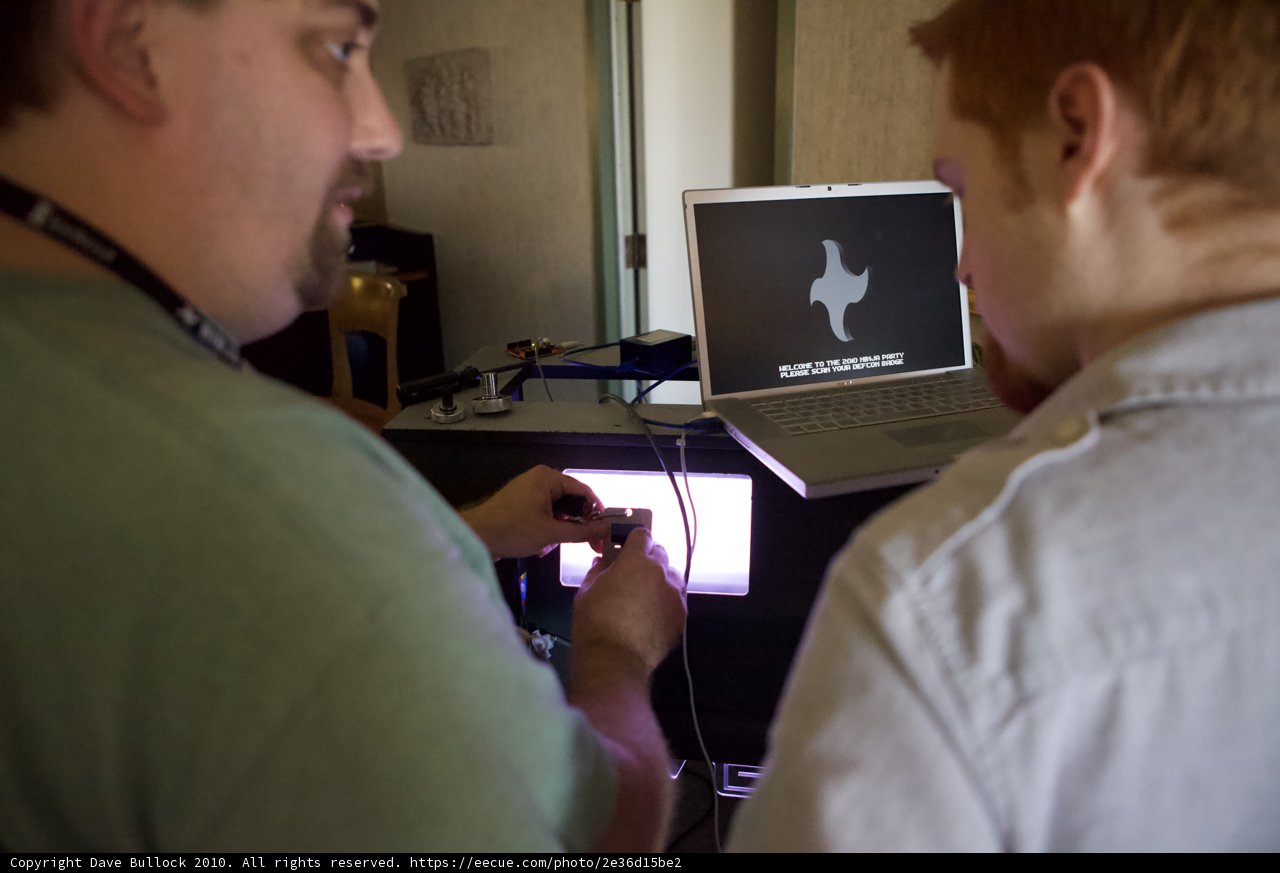 Two Men Working On A Laptop Computer