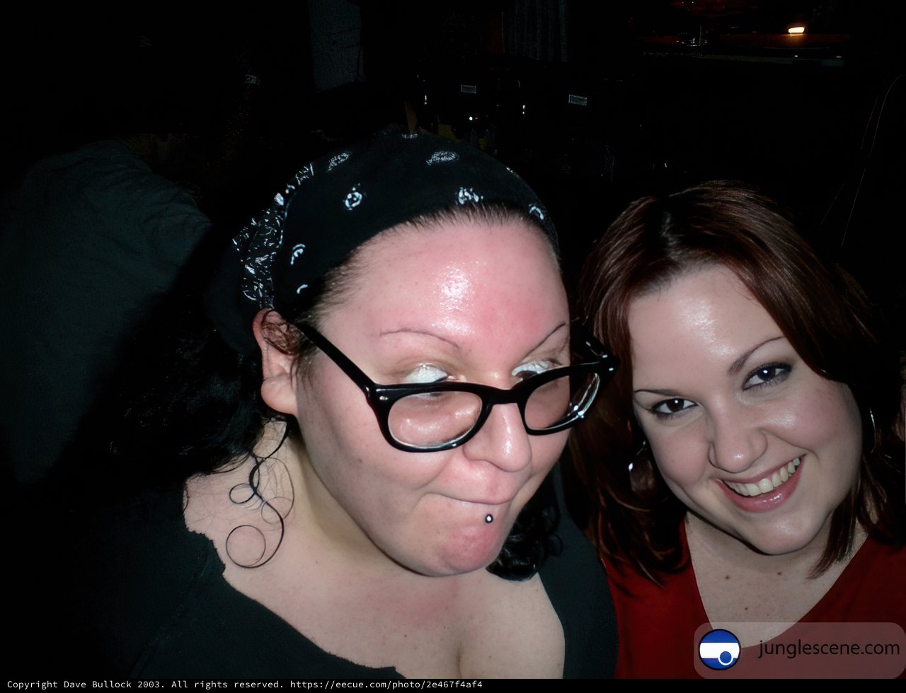 Two Women Strike a Pose in Glasses and Hats