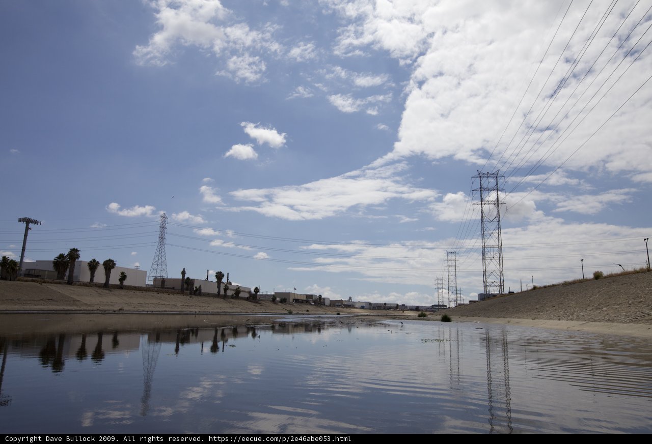 Towering Power Lines and Tranquil River