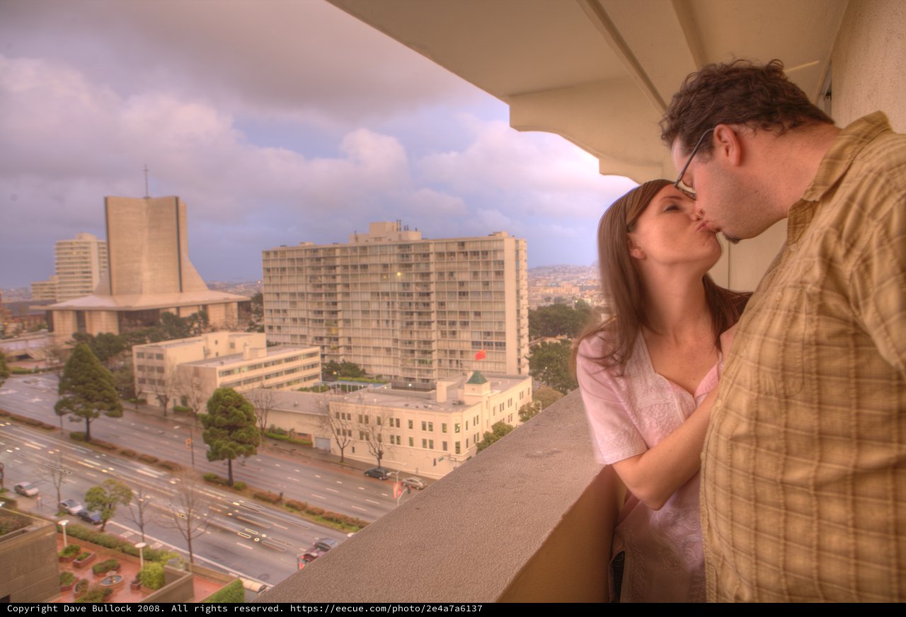 Romantic Balcony Kiss Over San Francisco Cityscape