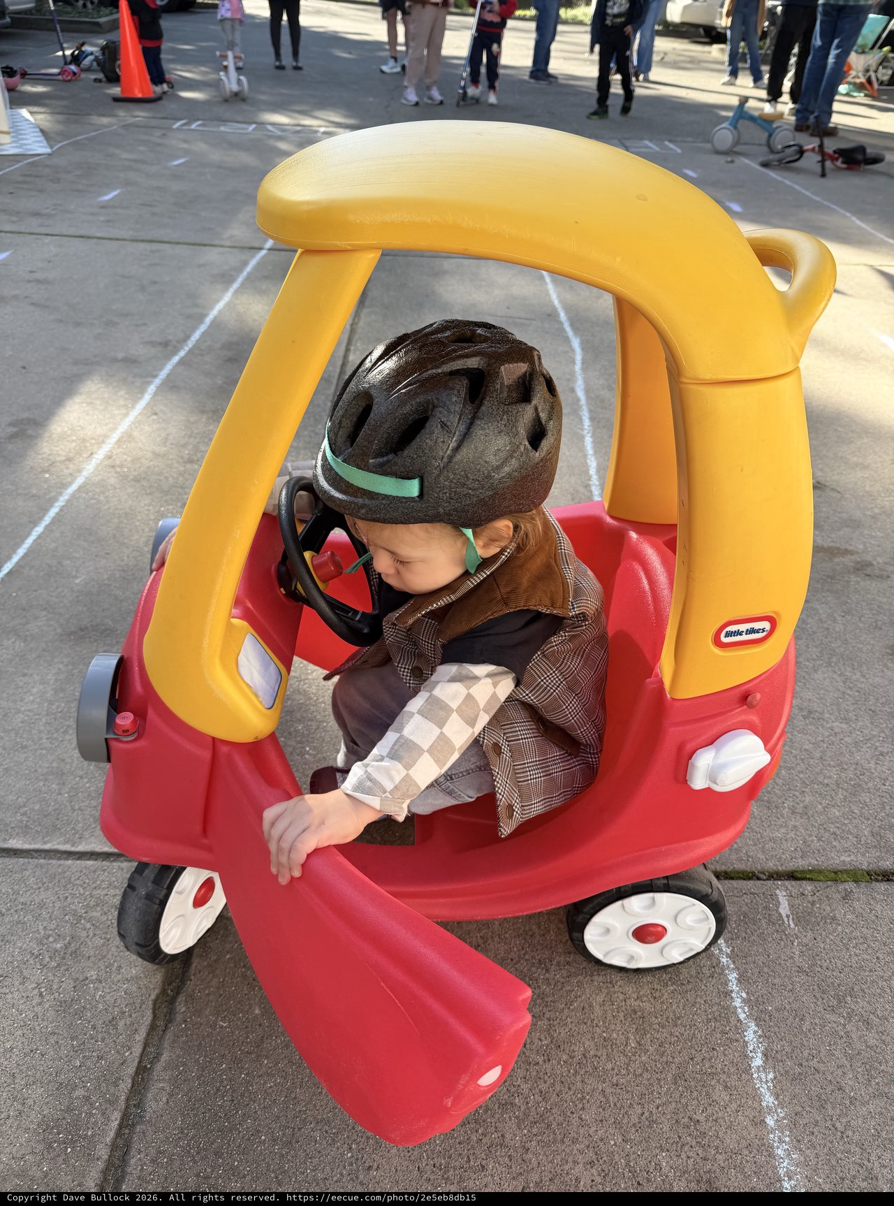 Young Child in Little Tikes Car at Community Event