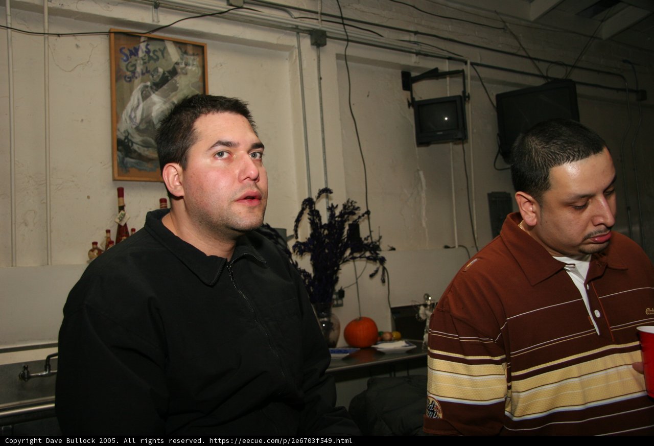 Brown Shirted Man Enjoys Music and Art with Friends