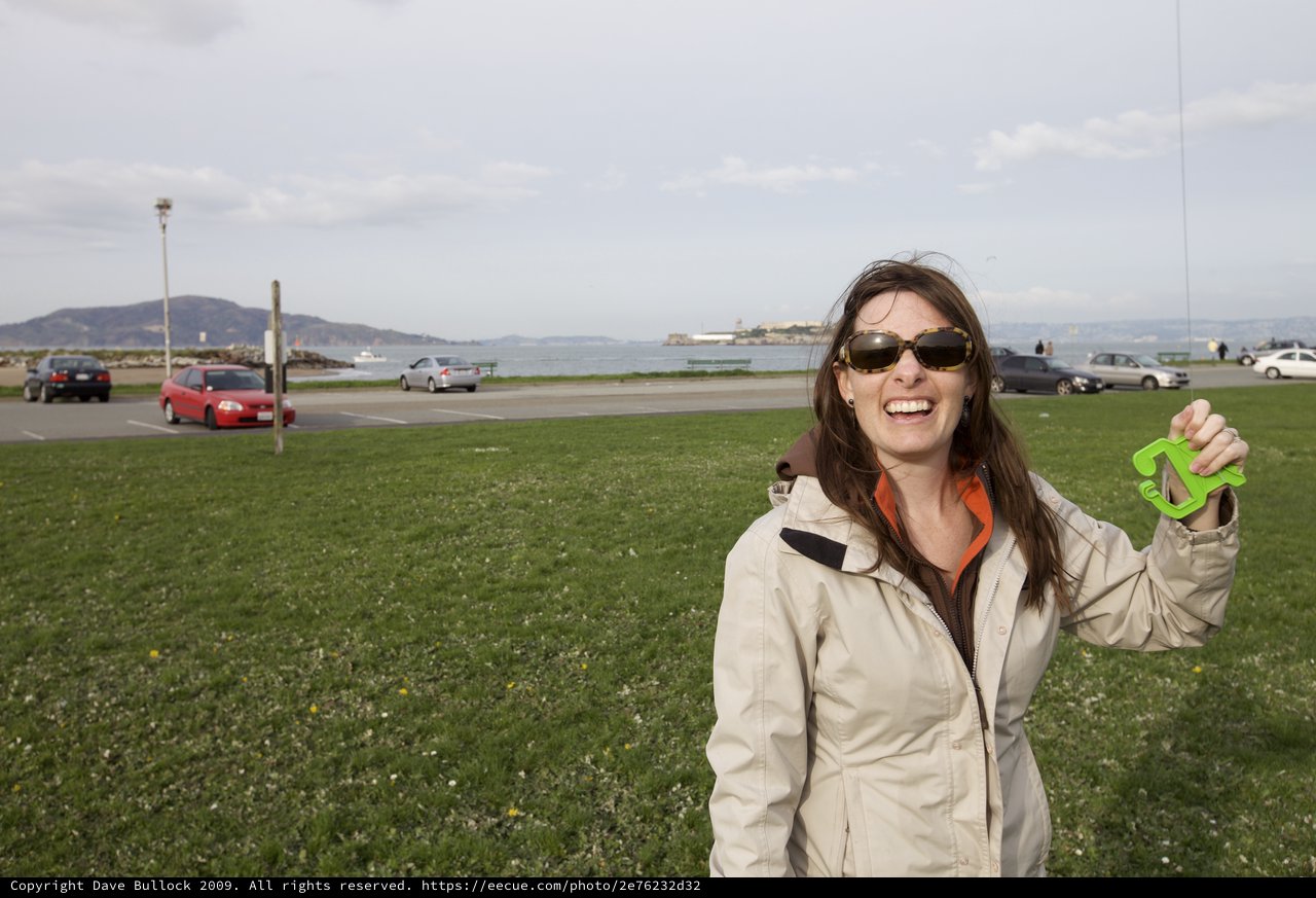 Laughing Woman Flying Kite by San Francisco Bay