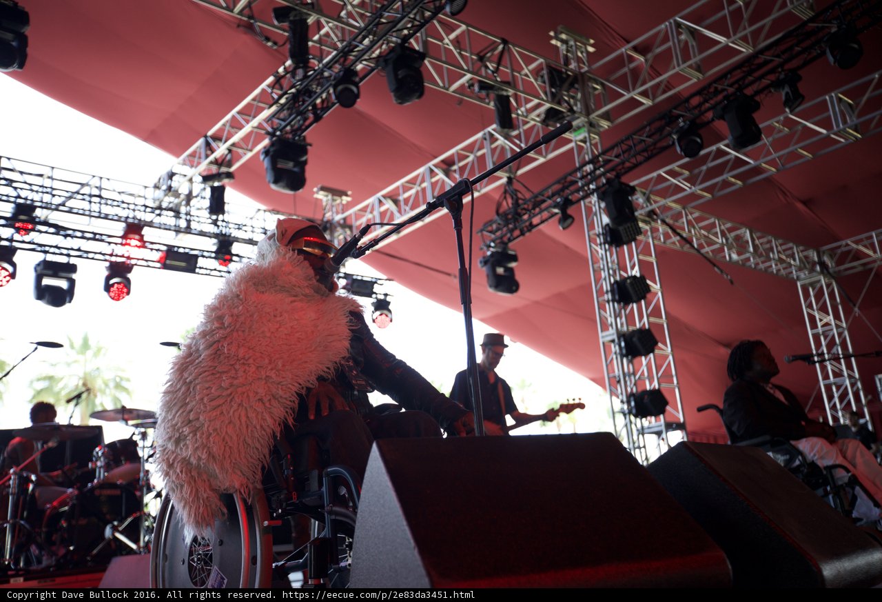 Man in Costume Shines on Stage with Mic