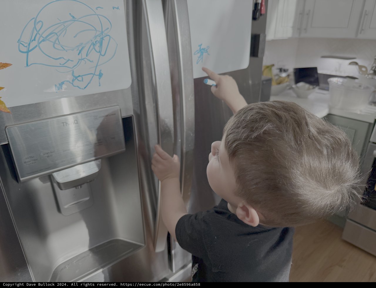 Toddler Drawing on Stainless Steel Refrigerator