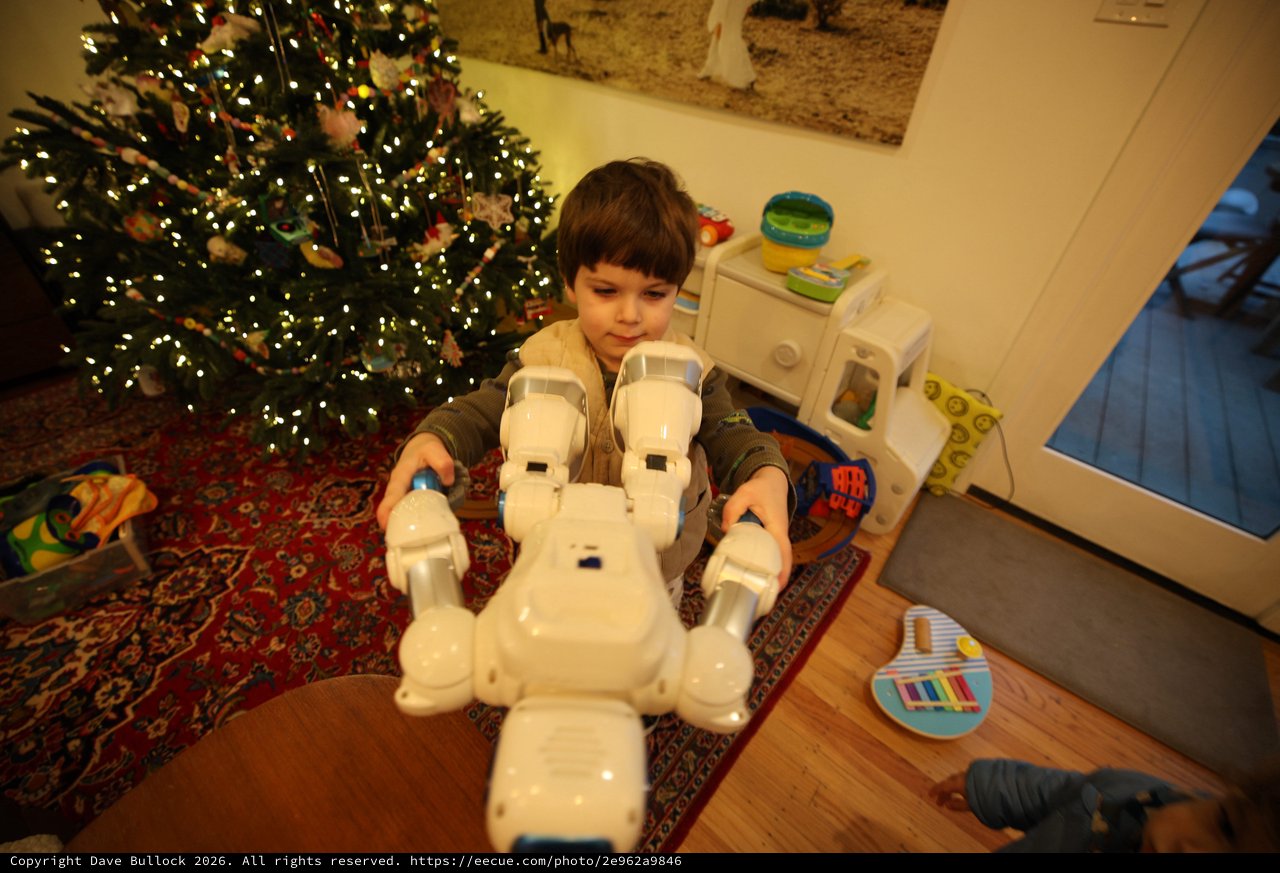 Child Playing with White Robot Toy on Christmas Morning