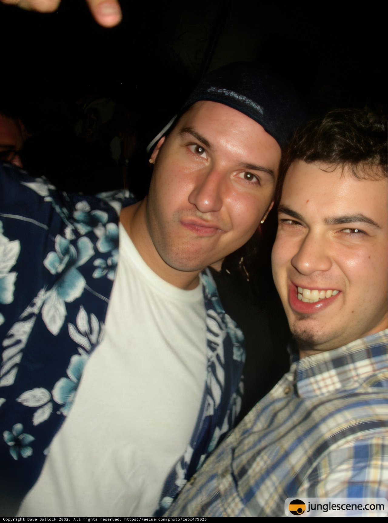 Two Men Strike a Pose in Baseball Hats