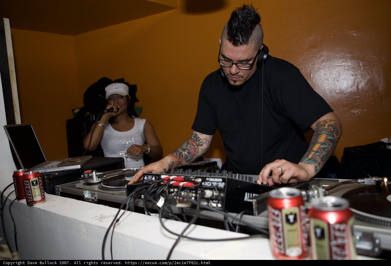 Dubstep DJ mixing tunes wearing signature tattoos