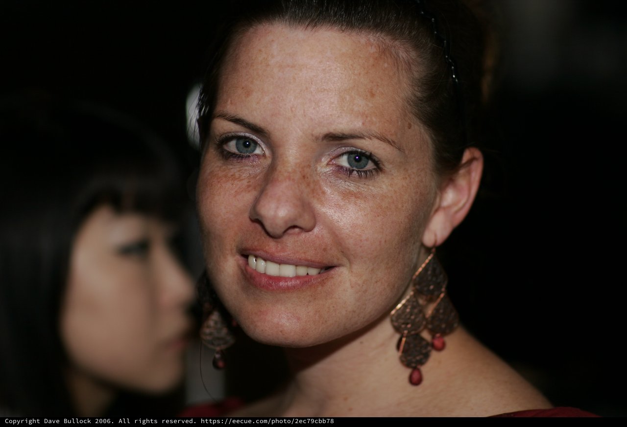 Smiling Woman with Freckles at Evening Event