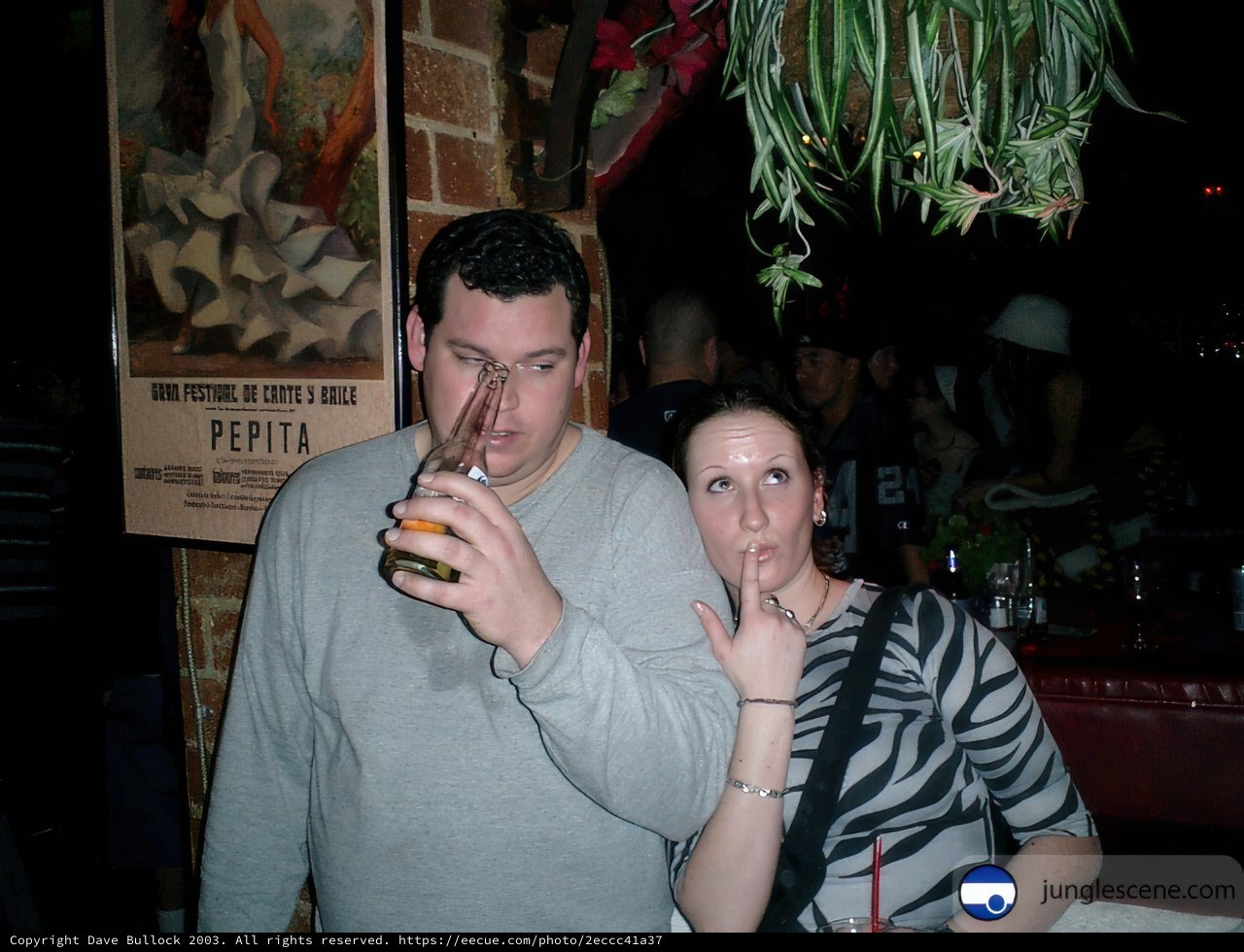 Cheers to the Night Caption: Two men and a woman toast to a night of fun at the local pub, holding their beers and showing off their accessories. The urban scene behind them adds to the lively atmosphere of the photo.