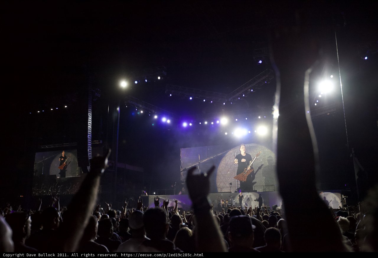 Rockin' with the Crowd Caption: The electric energy of the Big Four Festival's outdoor rock concert was amplified by the enthusiastic audience with their hands up in the spotlight.