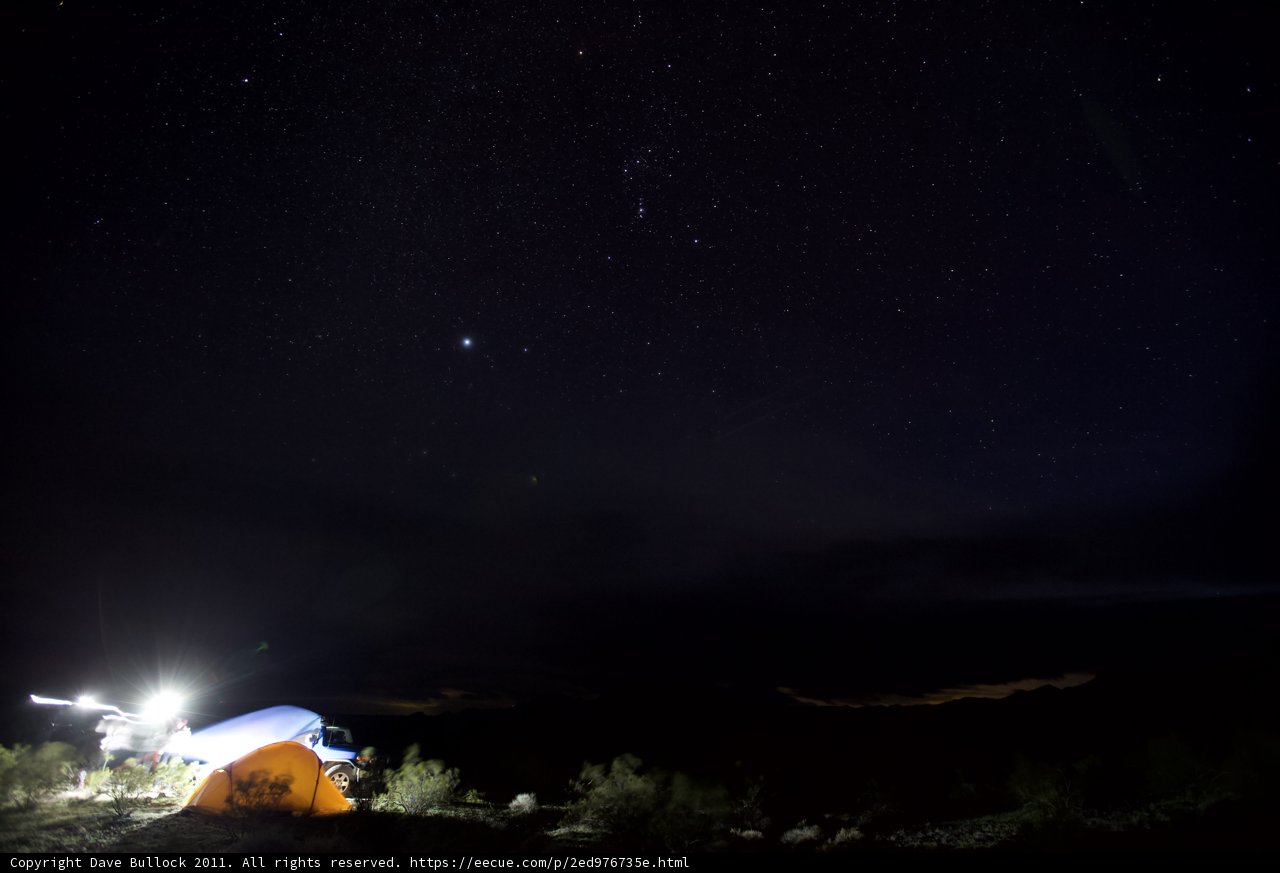 Mountain Tent Illuminated Under Starry Sky
