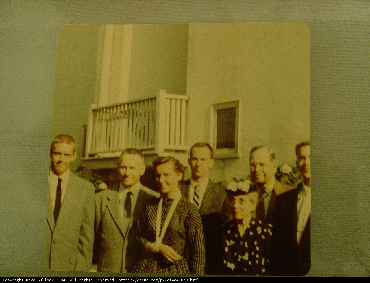 Group of People in Formal Wear Posing in Front of Building