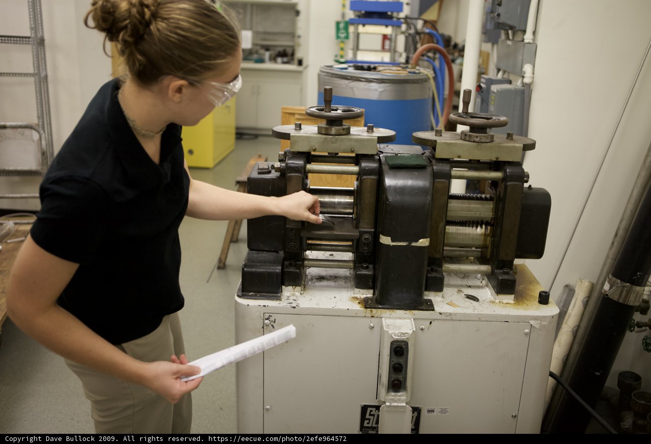 Female Engineer Working on Machine in Factory