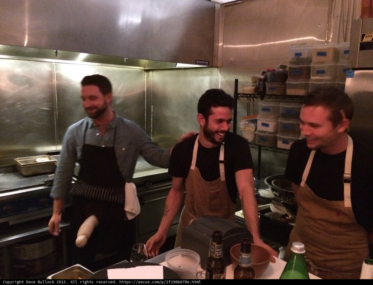 Three Men Preparing a Meal in a Restaurant Kitchen