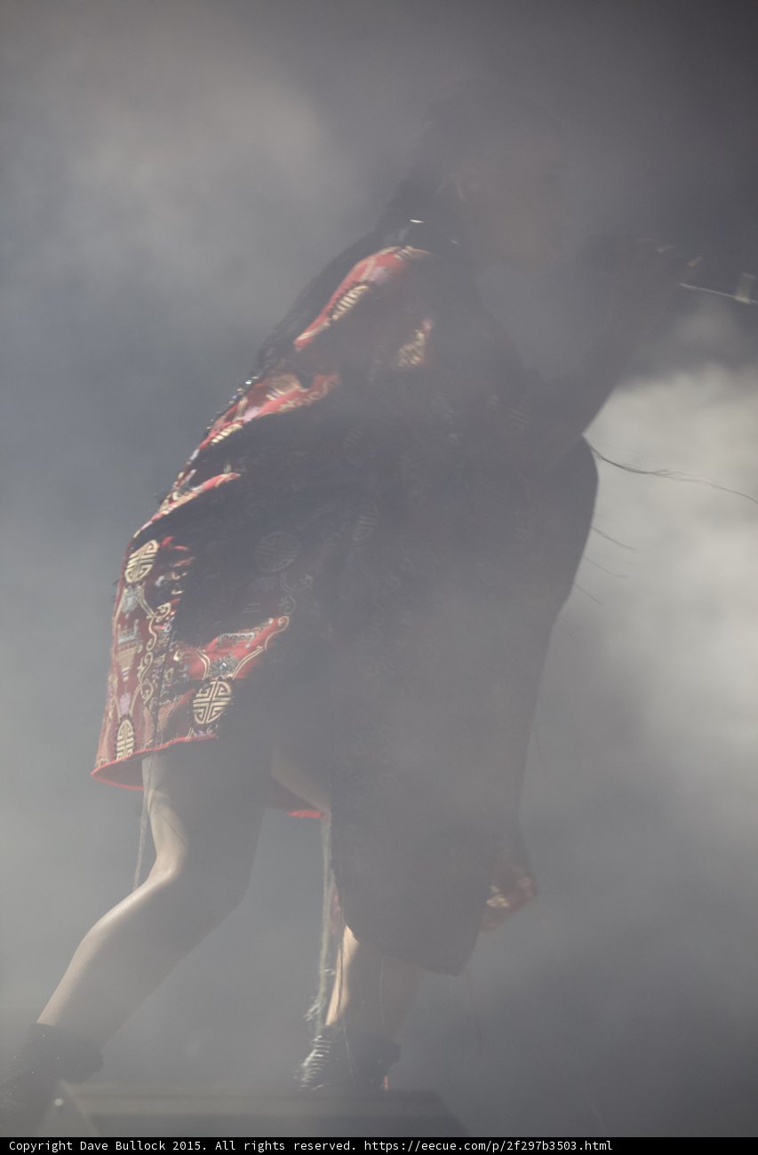 FKA twigs Dynamic Leaning Forward Red Brocade Kimono Gold Chinese Patterns Fringe Border Braided Ponytails Black Boots Heavy Haze