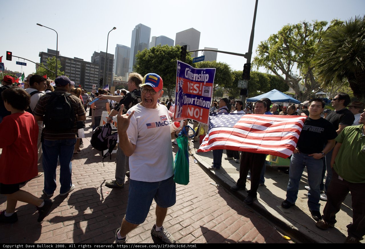 Mayday Rally with Man holding Flag and Sign
