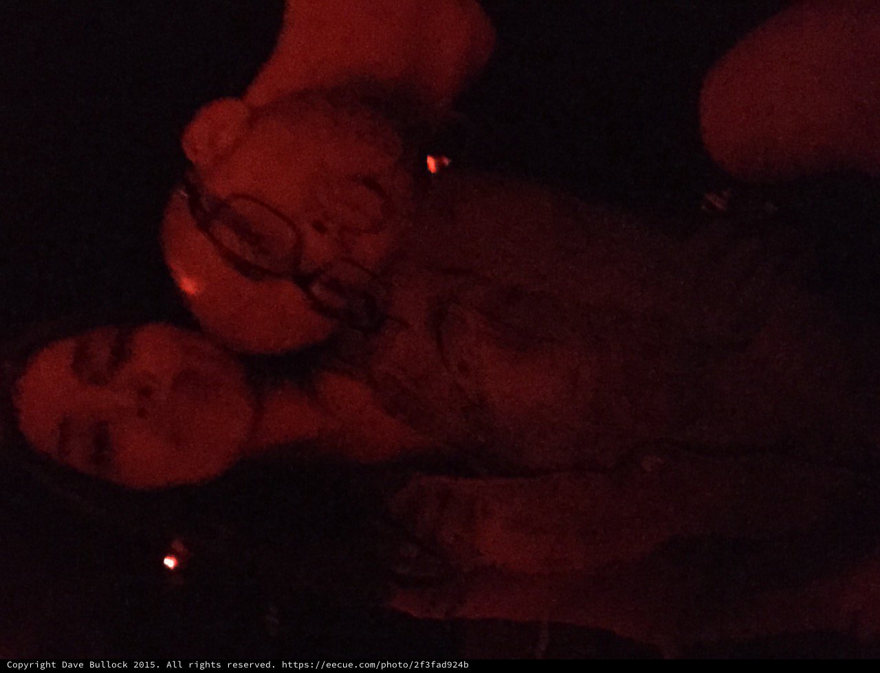 Two Friends Bathed in Red Light at Night