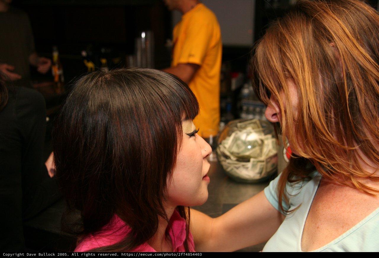 Two Women Share an Intimate Moment at a Bar