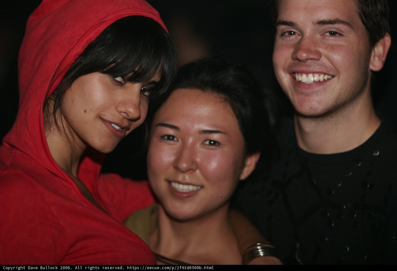 Smiling Couple and Friend at Wedding