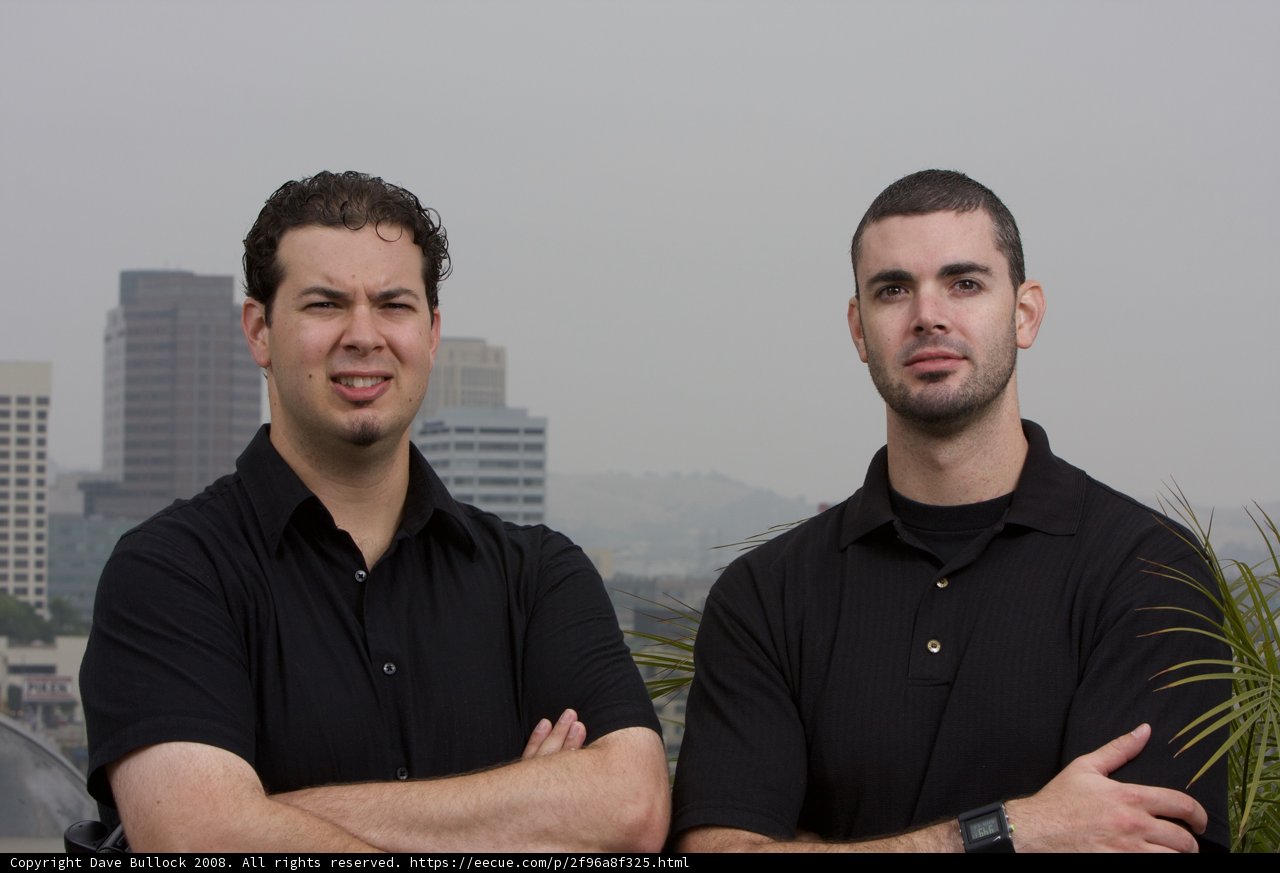 Two Happy Men in Black Shirts Enjoying Cityscape View