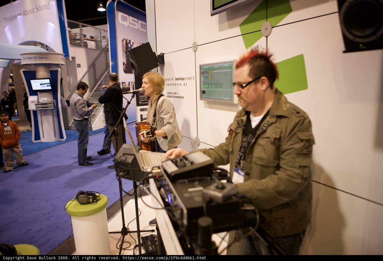 Musician Strums Guitar at NAMM Trade Show