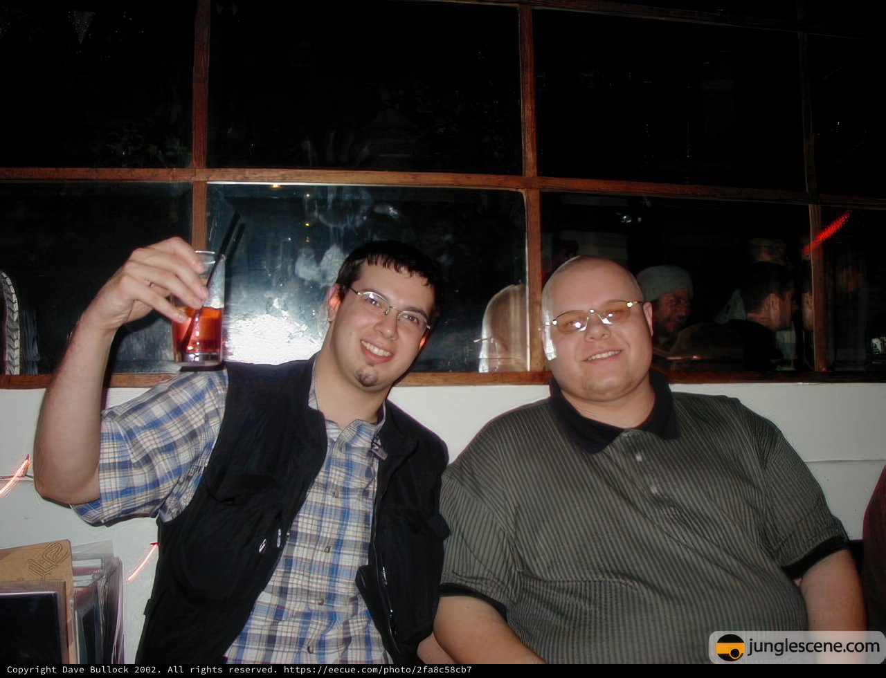 Two Men Enjoying Drinks at Urban Bar