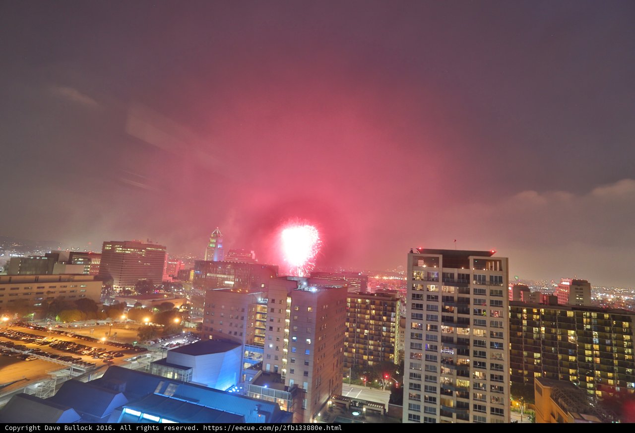 Fireworks illuminate the urban night sky