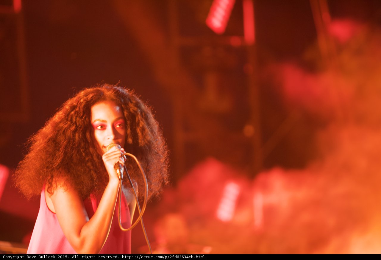 Solange Portrait Direct Gaze Singing Red Orange Atmospheric
