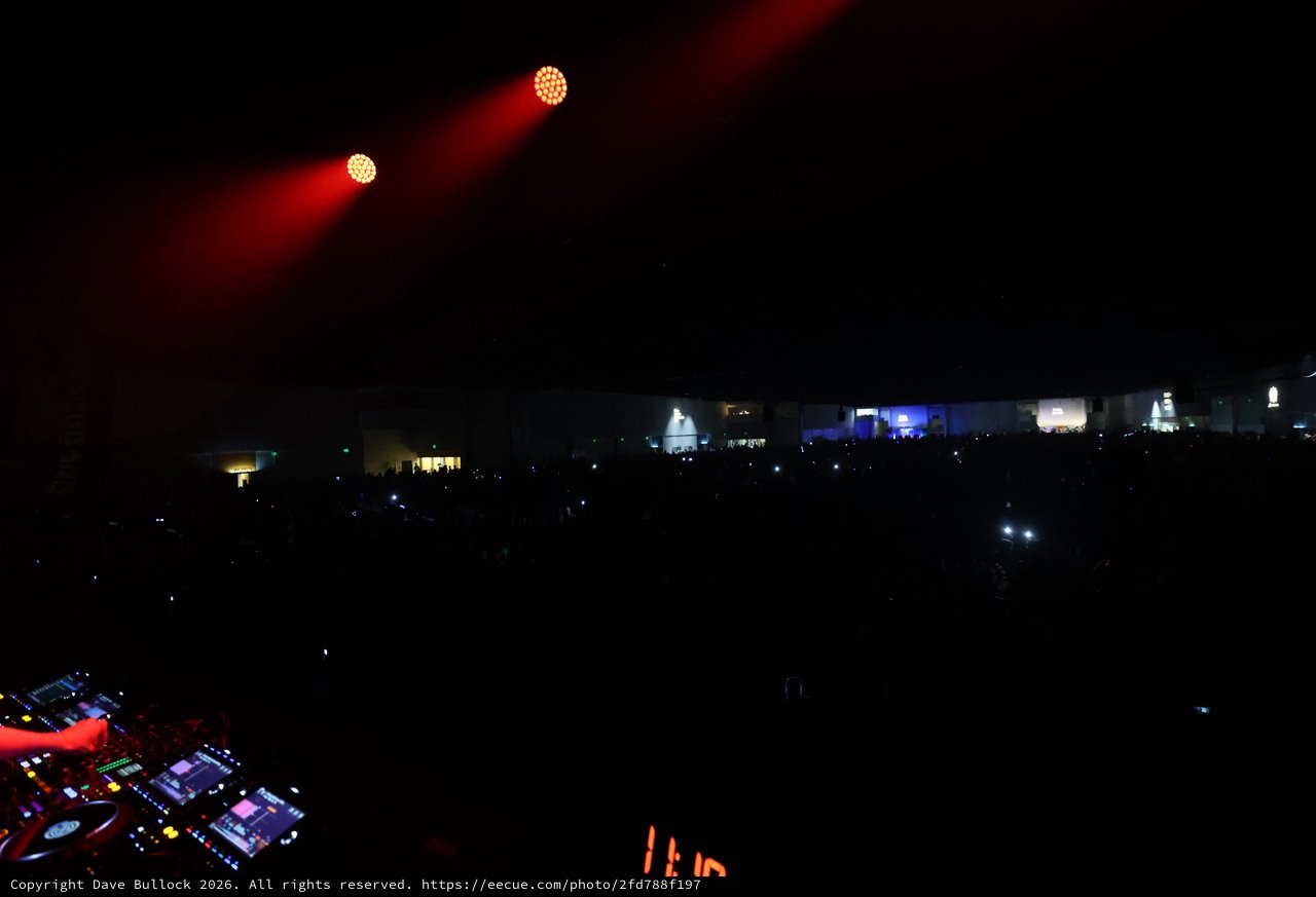 DJ Booth Perspective Over Massive Festival Crowd at Night