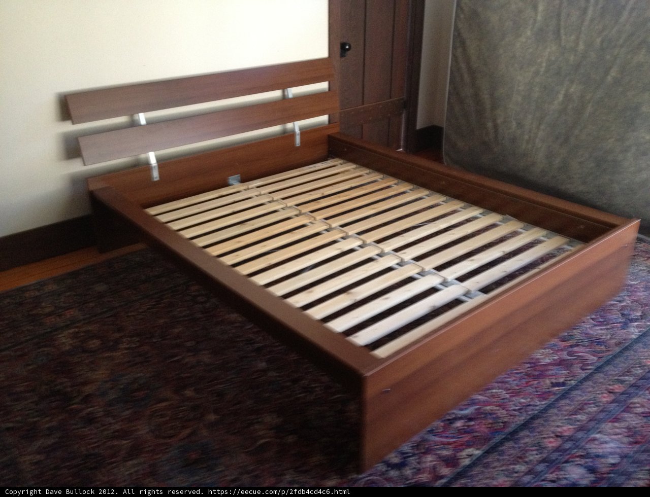 A Stained Hardwood Bed Frame with Slats