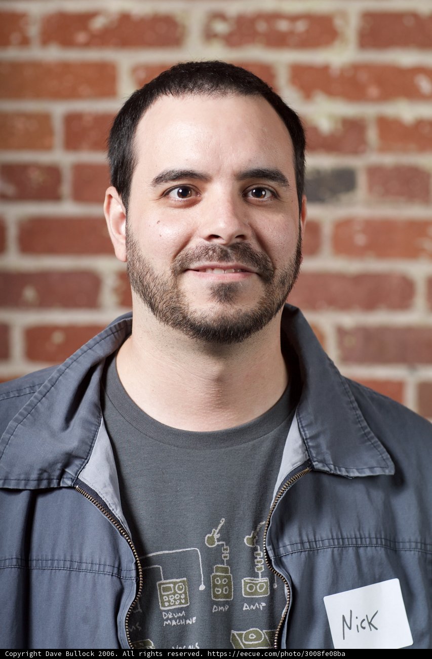 Smiling bearded man in gray shirt
