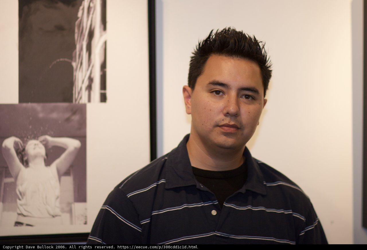 Man posing in front of art wall