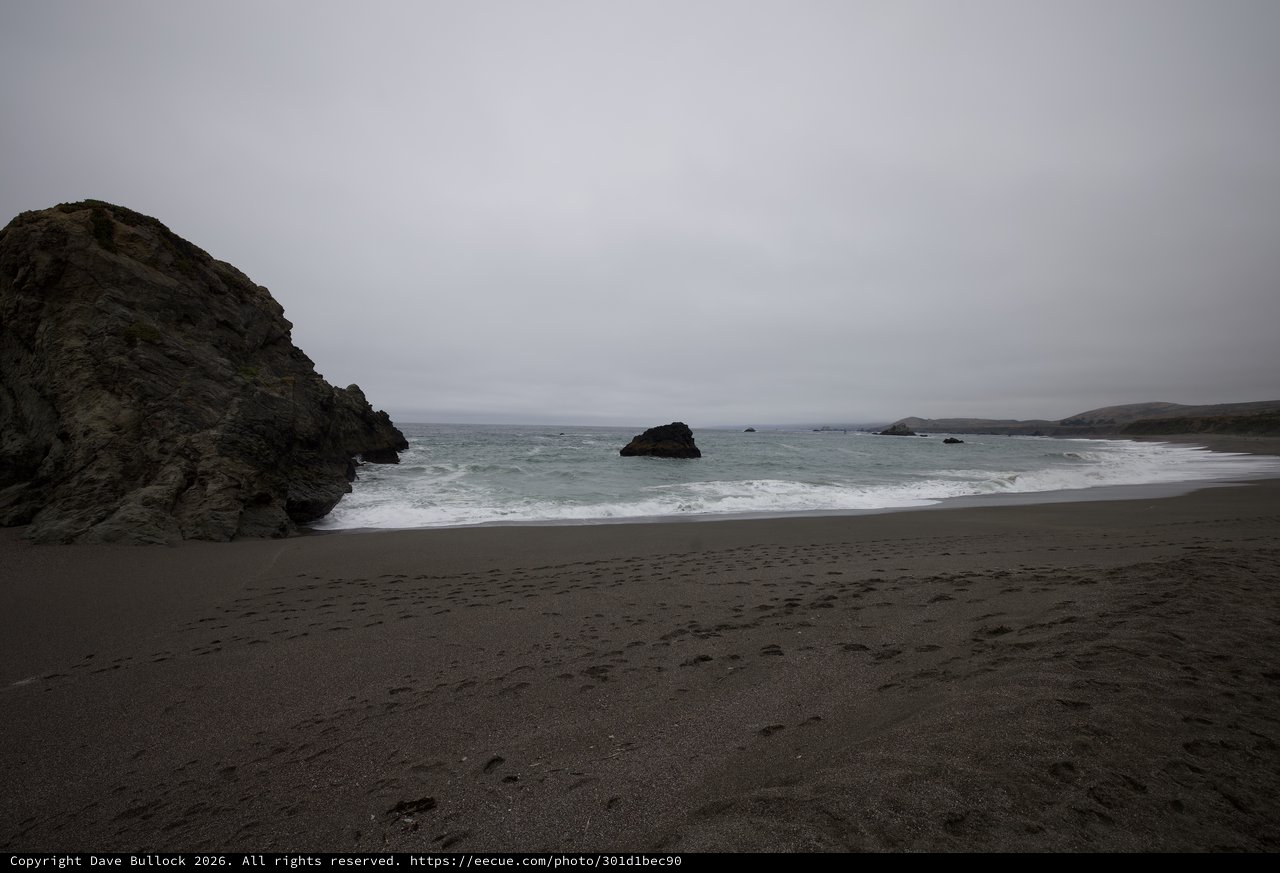 Moody Overcast Cove with Dark Volcanic Sand Beach