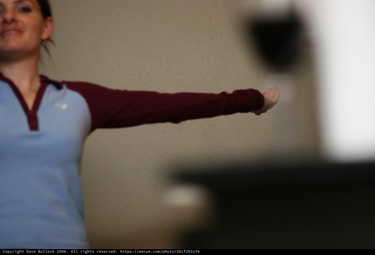 Woman Extends Arm in Dynamic Indoor Pose