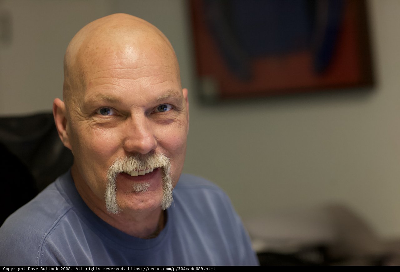 Smiling Bald Man in Blue Shirt