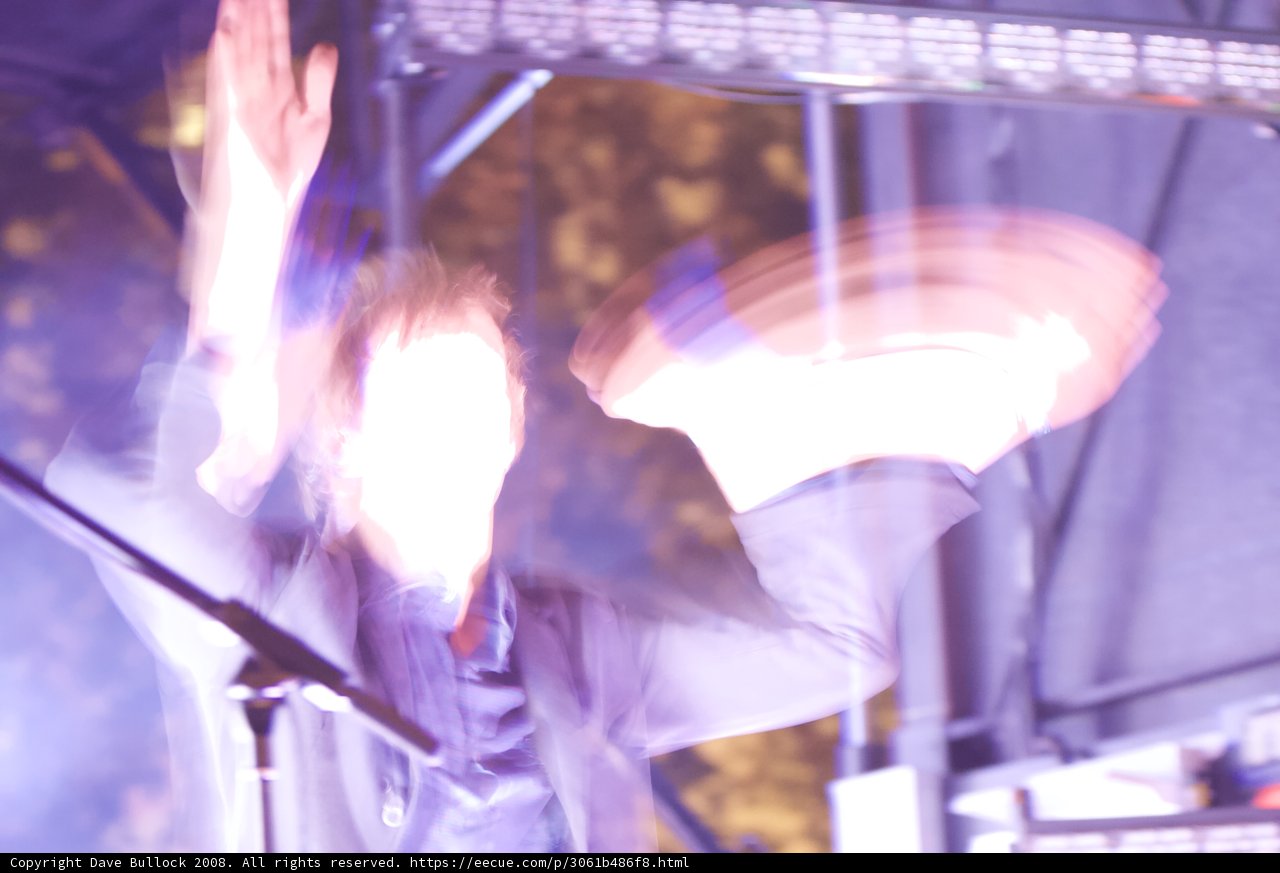 Blurred Man with Hands Up in Concert Crowd
