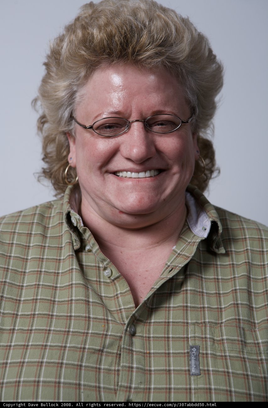 Happy Portrait of a Woman in Plaid and Glasses